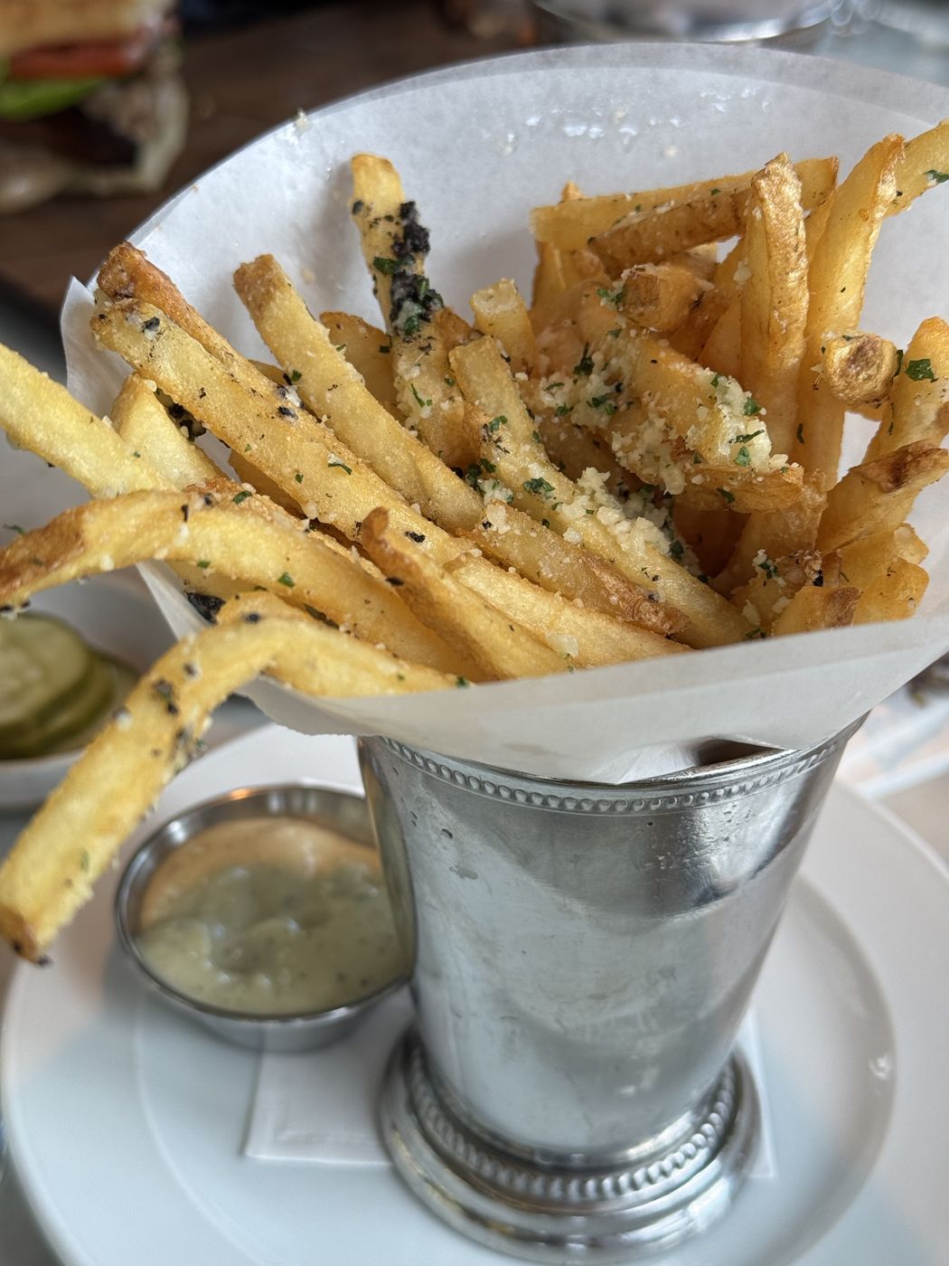 Parmesan truffle fries in a silver cup